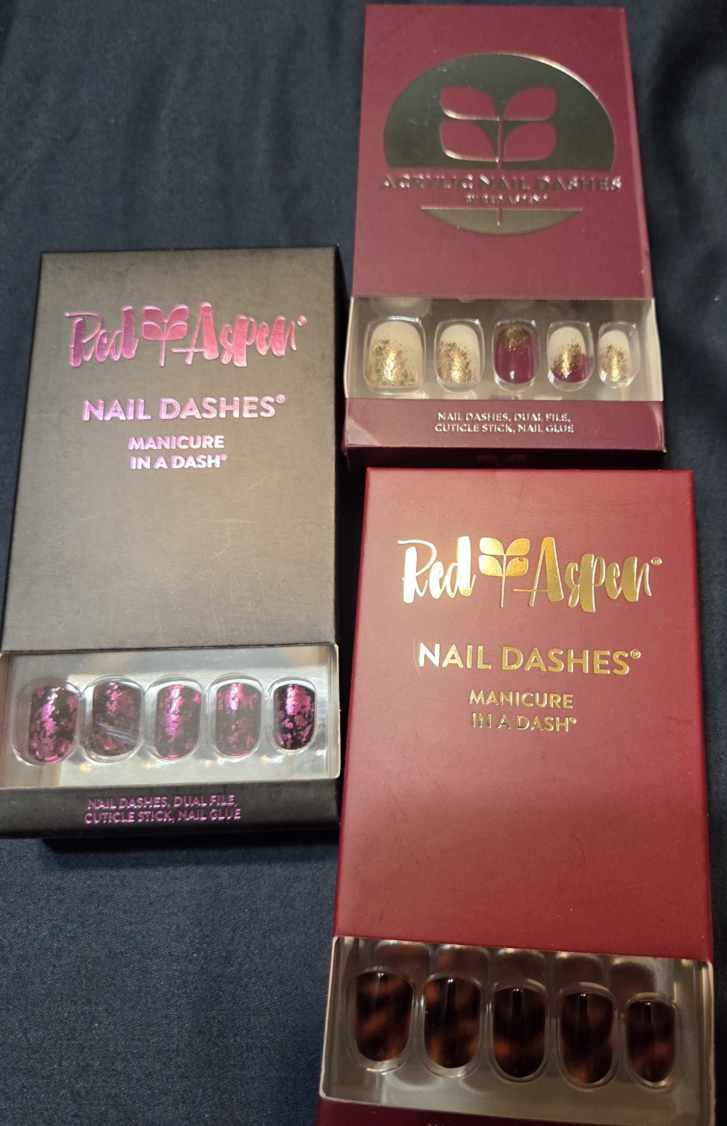 32 Sets of Red Aspen Press-On Nails including Acrylic and Multicolor Glitter