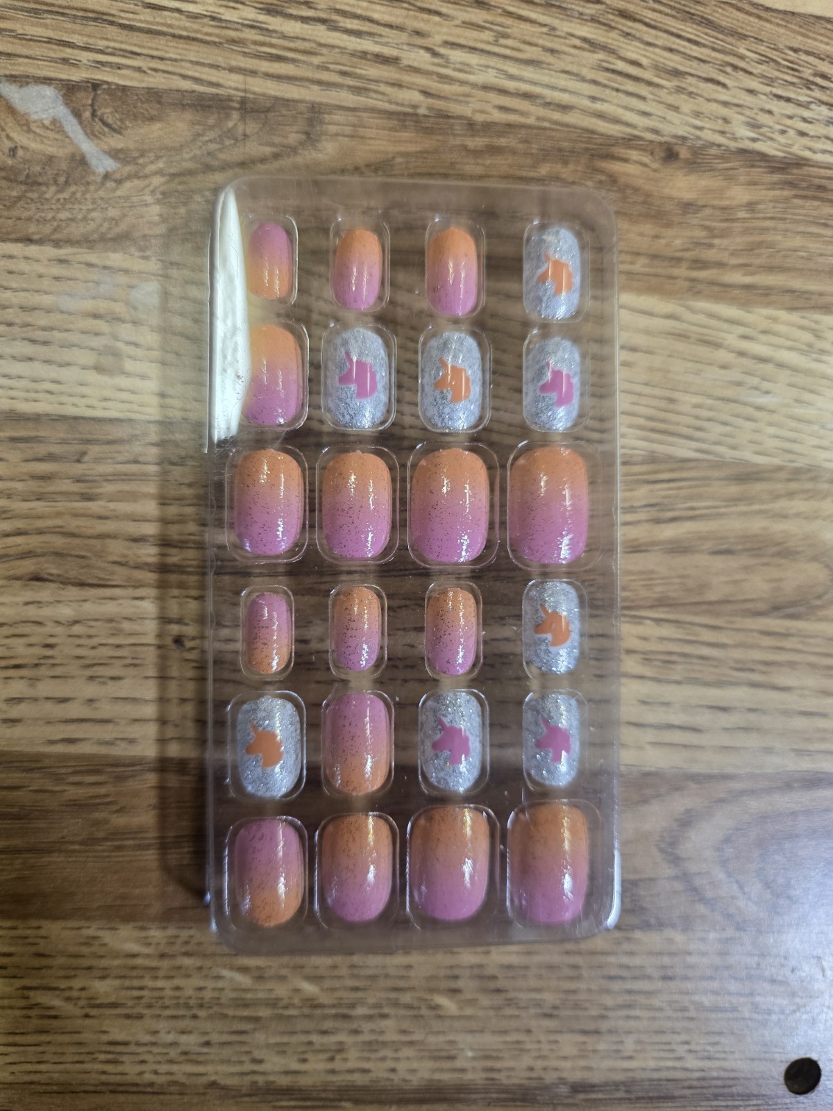 These Appear to Be Children’s Press-on Nails Featuring A Pink and Orange Design