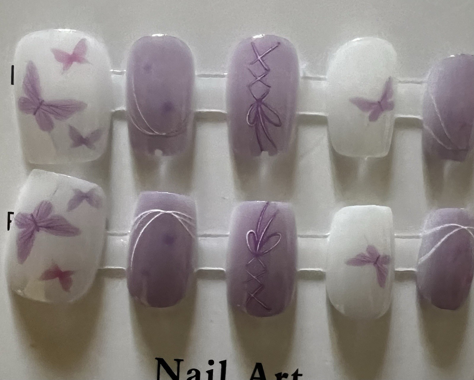 Set of 4 packs. Pink/White/Purple French Butterfly Press-On Nails Medium Oval.