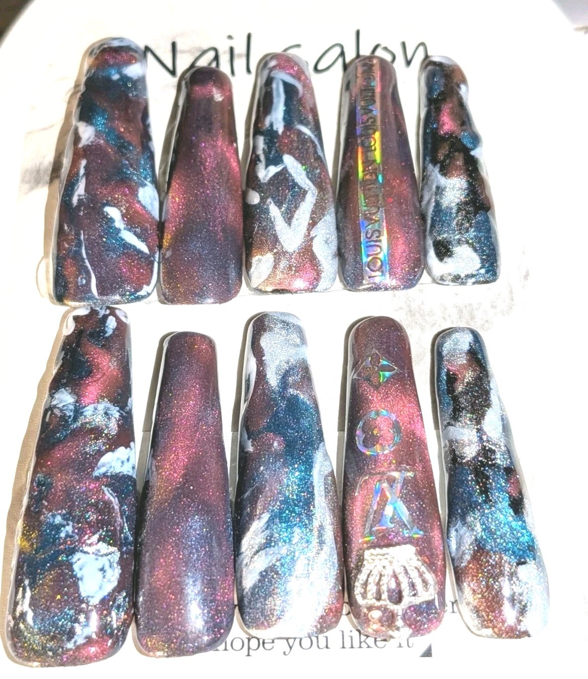 Shimmering Handmade Stunning galaxy-themed press-on nails with a mix of colors.