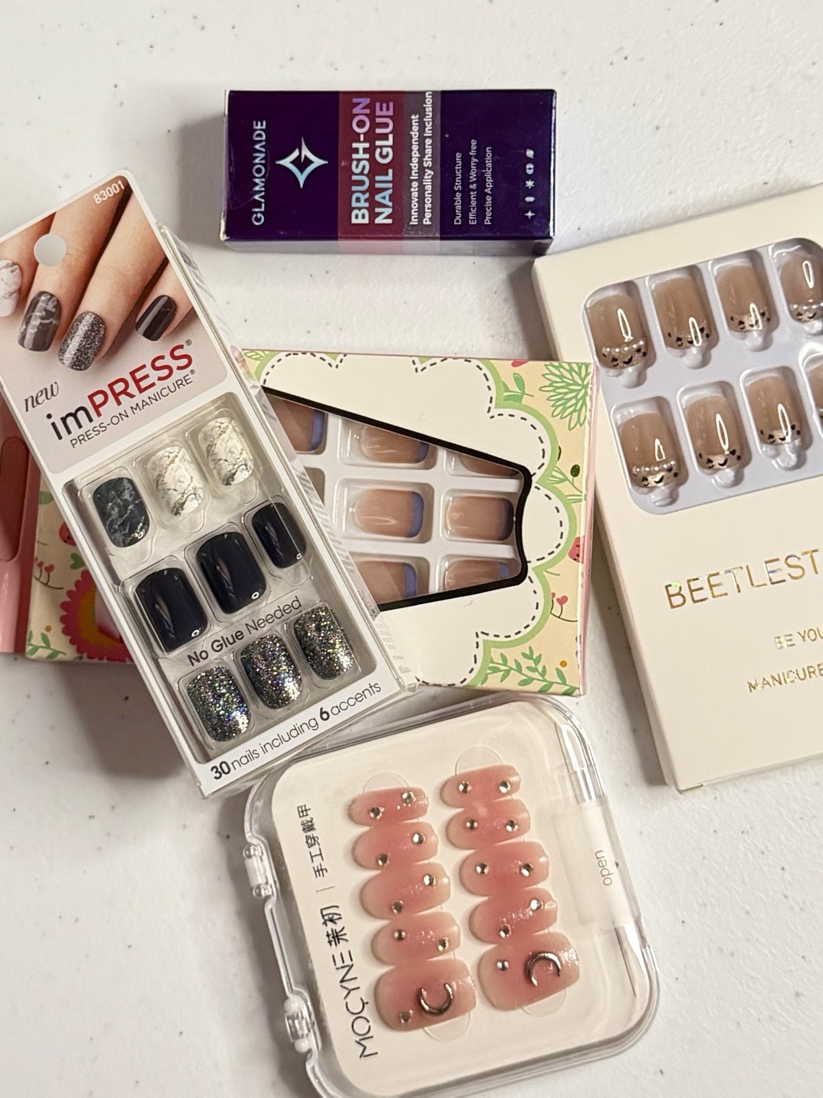 Short nail bundle. 4 sets, multiple sizes in each set. Brush on glue.