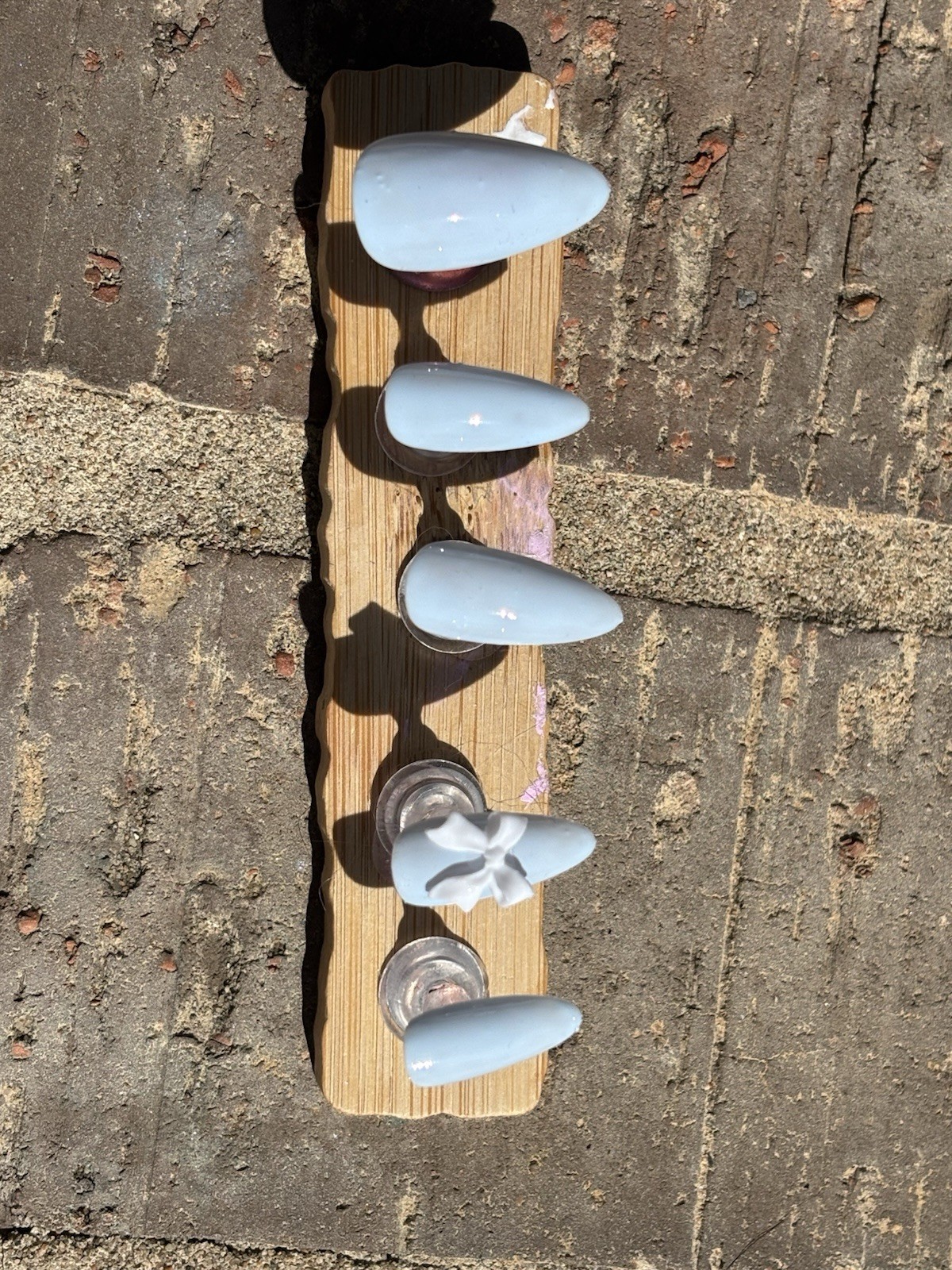 Handmade beauty in blue press on nails, fits all sizes!! With a white bow