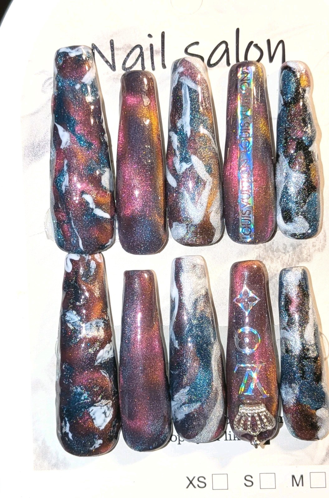 Shimmering Handmade Stunning galaxy-themed press-on nails with a mix of colors.